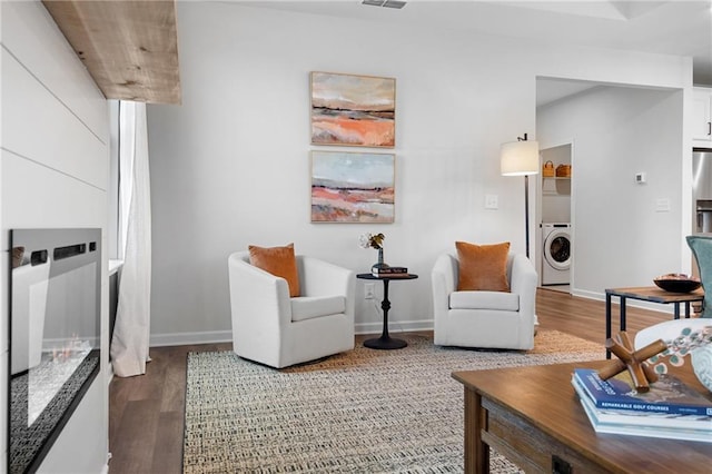 living room featuring hardwood / wood-style flooring and washer / dryer