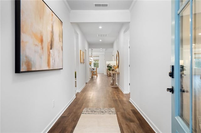 hall with crown molding and dark hardwood / wood-style flooring