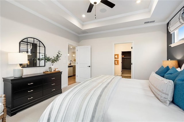 bedroom with sink, ceiling fan, ensuite bathroom, and a tray ceiling