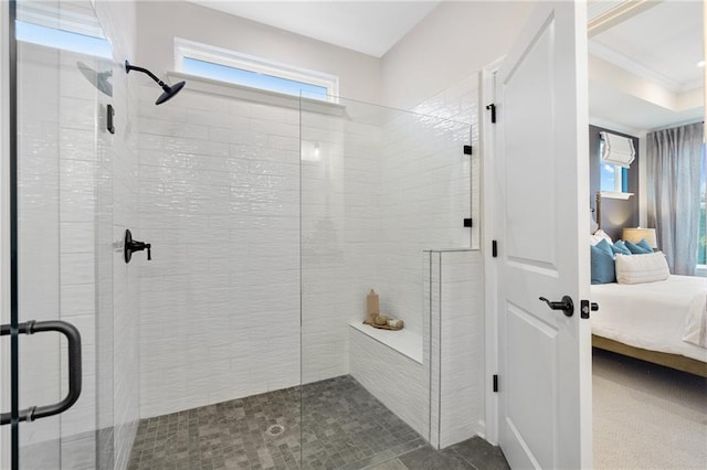 bathroom with a shower with door and ornamental molding