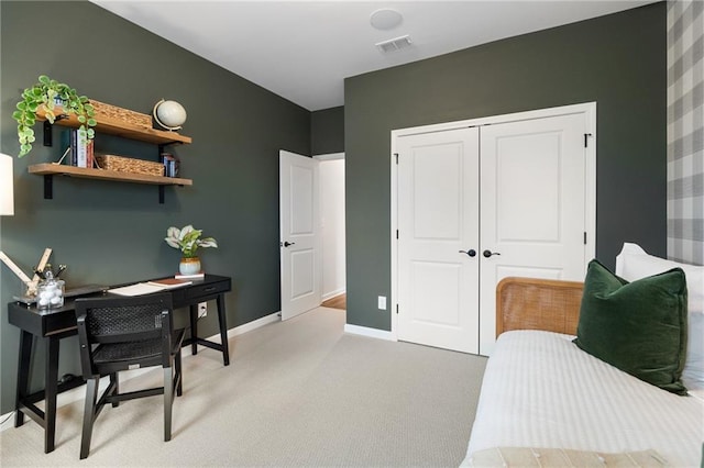 bedroom with light colored carpet and a closet