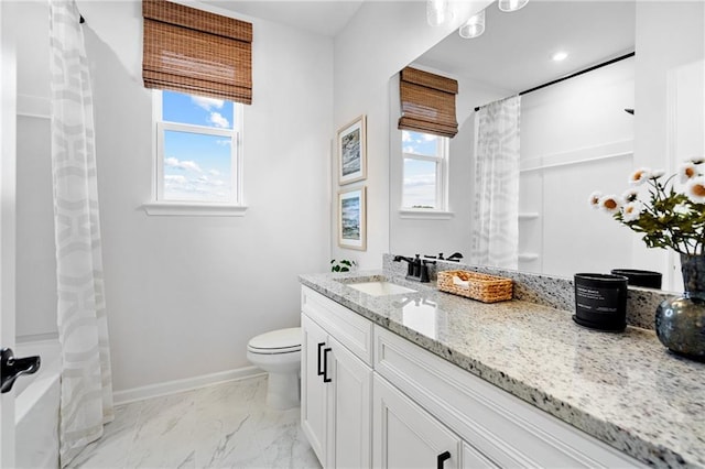 bathroom featuring vanity, toilet, and plenty of natural light