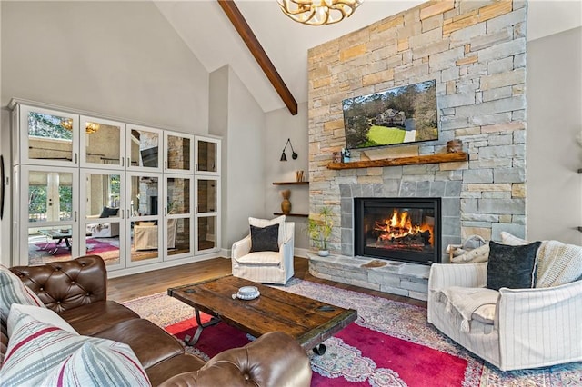 living room with hardwood / wood-style floors, beam ceiling, high vaulted ceiling, and a stone fireplace