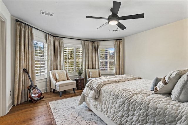 bedroom with hardwood / wood-style floors and ceiling fan