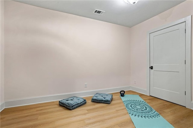 workout room featuring hardwood / wood-style floors