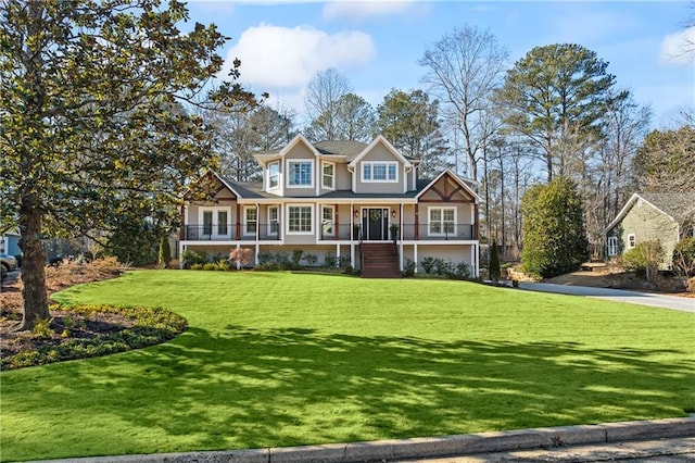 craftsman-style house with a front lawn and covered porch