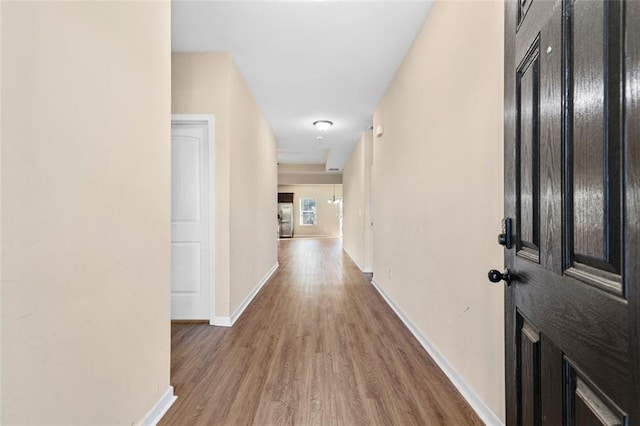 corridor with hardwood / wood-style floors