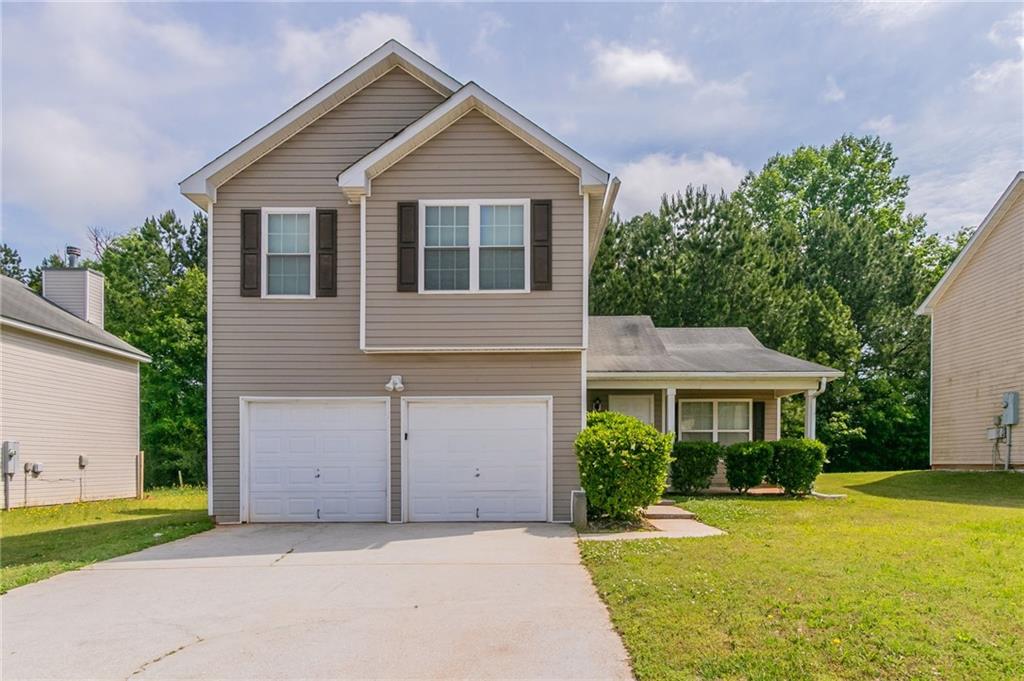 4870 Heather Mill Trce, Snellville, GA 30039 - view of front of house featuring concrete driveway, a front lawn, and a garage