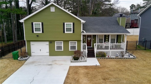 split level home featuring covered porch, fence, concrete driveway, and roof with shingles