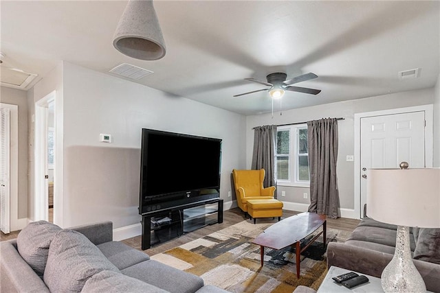 living room with ceiling fan and light wood-type flooring