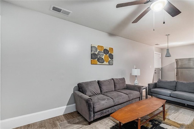 living room with ceiling fan and hardwood / wood-style floors