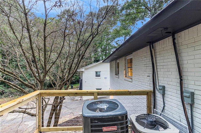 wooden deck featuring central air condition unit