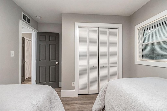 bedroom featuring a closet and wood-type flooring