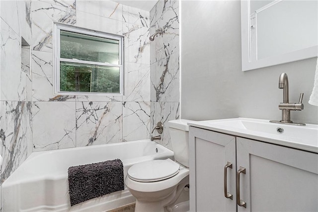 full bathroom featuring tiled shower / bath combo, toilet, and vanity