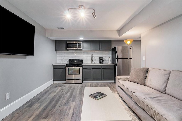 living room featuring hardwood / wood-style floors and sink