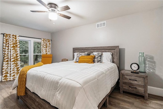 bedroom with ceiling fan and dark wood-type flooring