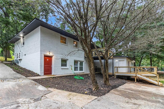 rear view of house with central air condition unit and a wooden deck