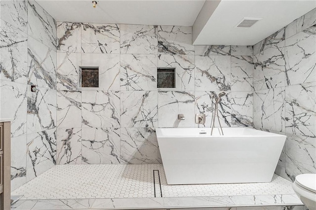 bathroom with vanity, tile walls, and toilet