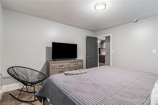 bedroom with hardwood / wood-style flooring