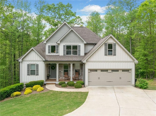 craftsman-style house featuring a garage, roof with shingles, board and batten siding, concrete driveway, and a porch