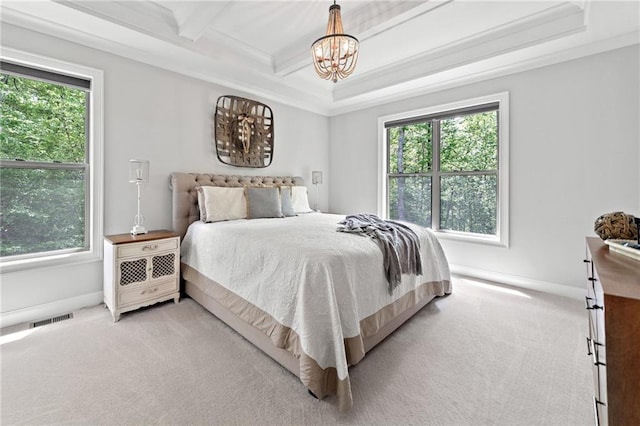 bedroom featuring multiple windows, light carpet, and a chandelier