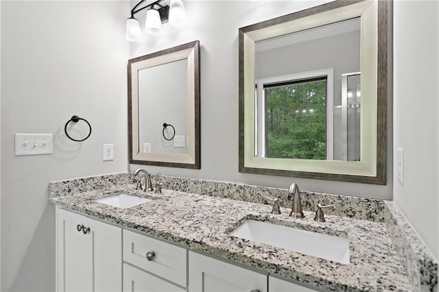 bathroom with a sink and double vanity