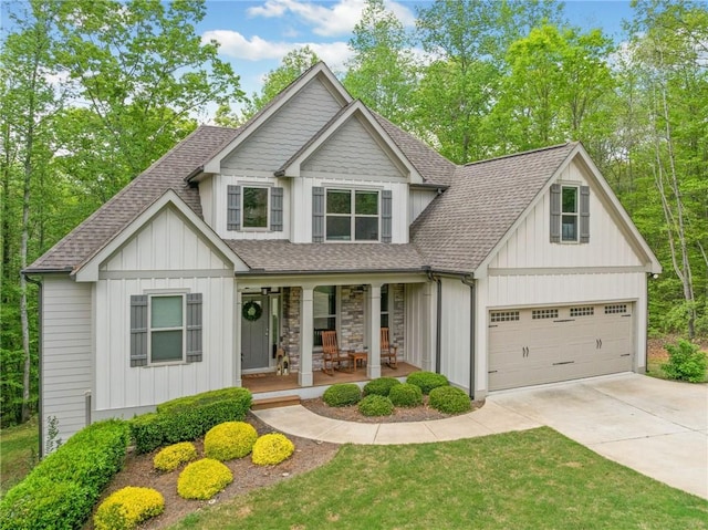 view of front of house featuring a garage, covered porch, a shingled roof, board and batten siding, and driveway