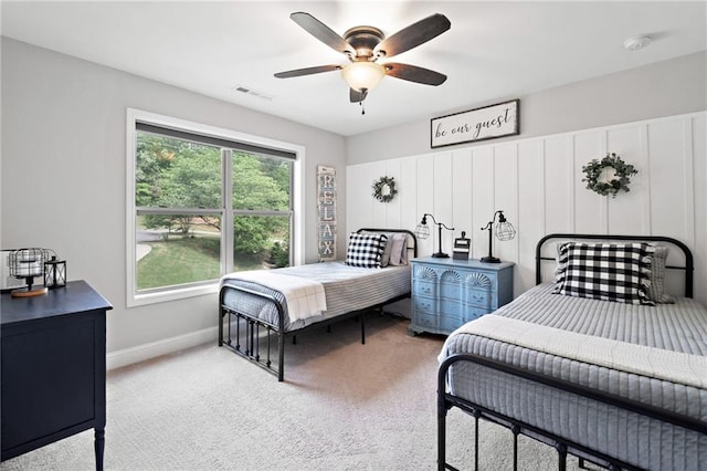 bedroom featuring baseboards, light carpet, a ceiling fan, and visible vents