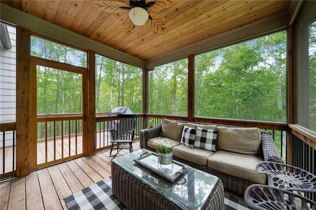 sunroom / solarium with plenty of natural light, outdoor lounge area, and a ceiling fan