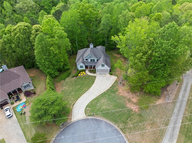 aerial view featuring a wooded view