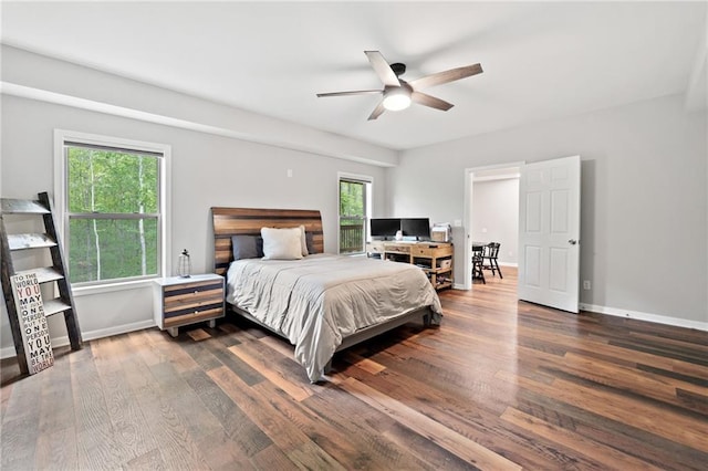 bedroom featuring baseboards, a ceiling fan, and dark wood-type flooring
