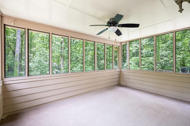 unfurnished sunroom with a ceiling fan