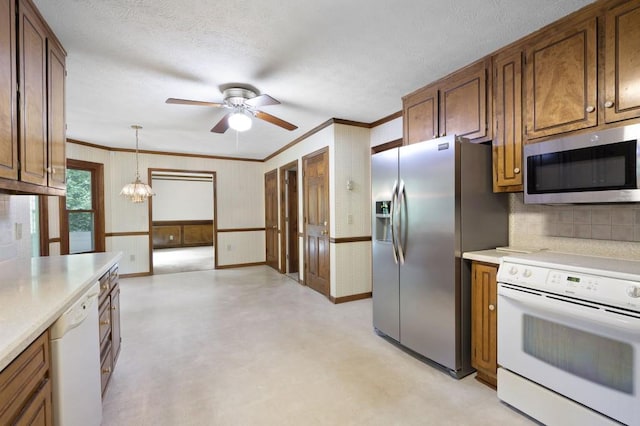 kitchen featuring appliances with stainless steel finishes, ceiling fan, light flooring, light countertops, and crown molding