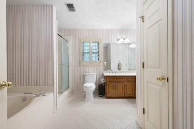 bathroom featuring toilet, a stall shower, vanity, a garden tub, and a textured ceiling