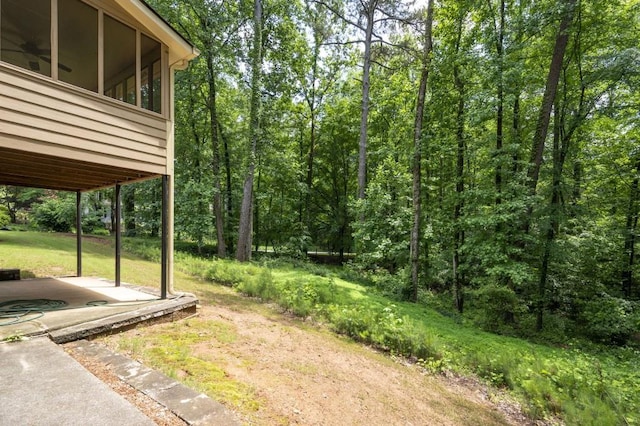view of yard featuring a forest view