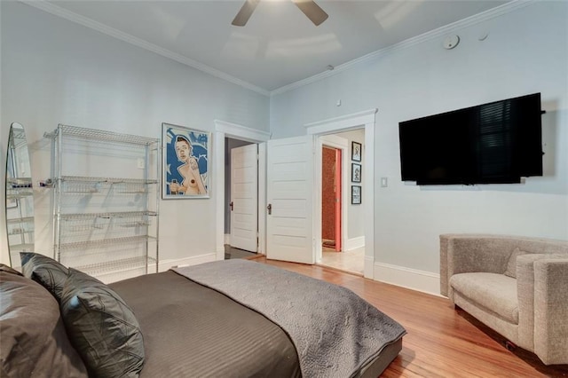 bedroom featuring hardwood / wood-style floors, ceiling fan, and ornamental molding