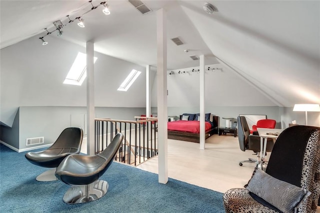 bedroom featuring lofted ceiling with skylight and light carpet