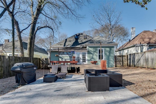 back of property with outdoor lounge area, a patio, and a deck