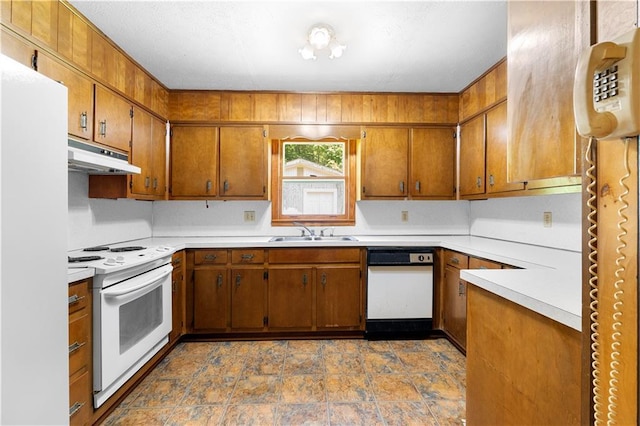 501 Samaritan Dr, Cumming, GA 30040 - kitchen featuring white appliances, under cabinet range hood, brown cabinetry, and light countertops