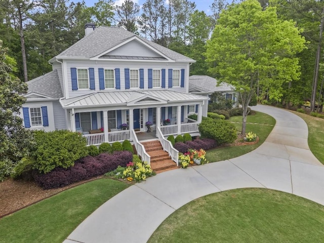 view of front of house with a porch and a front yard