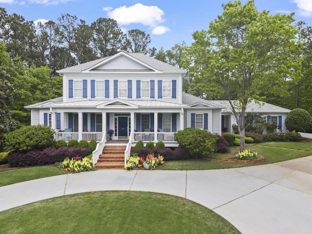 view of front of home with a front yard and a porch