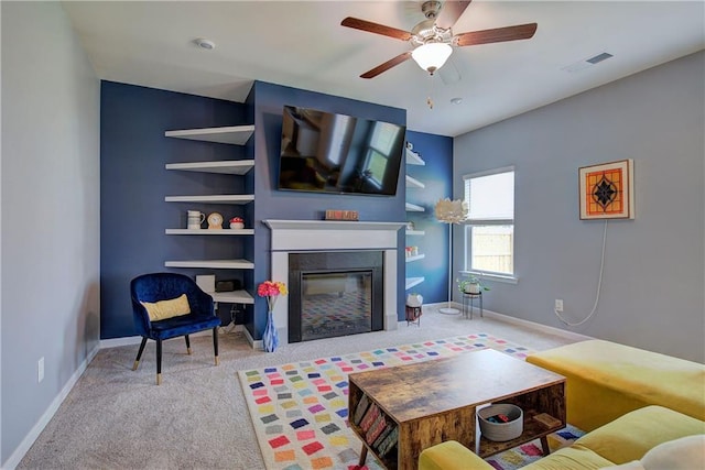 carpeted living room with ceiling fan