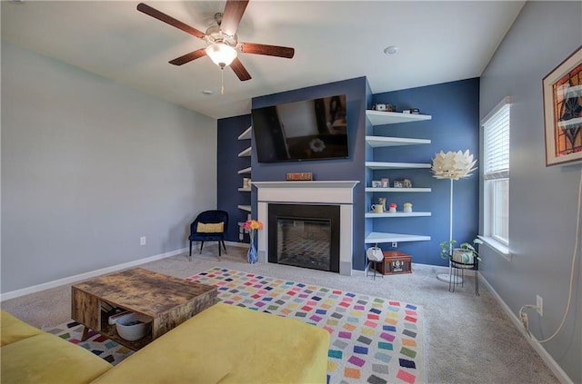 carpeted living room with ceiling fan