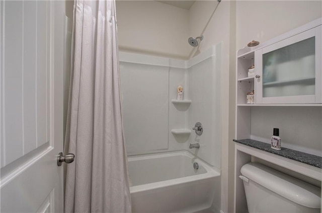 bathroom with shower / tub combo with curtain and toilet