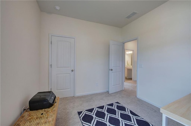 bedroom featuring light colored carpet