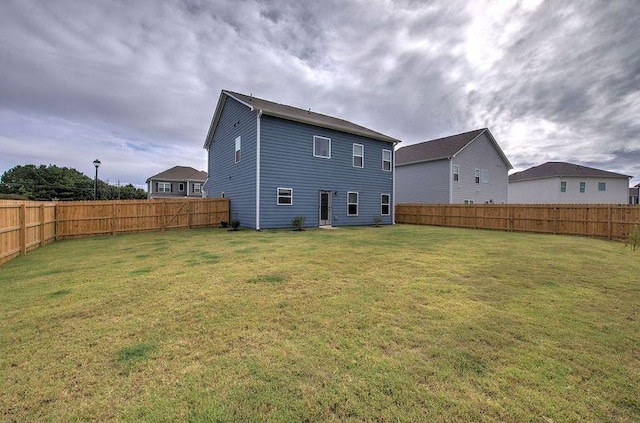 rear view of property with a lawn