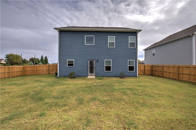 back of house featuring a yard