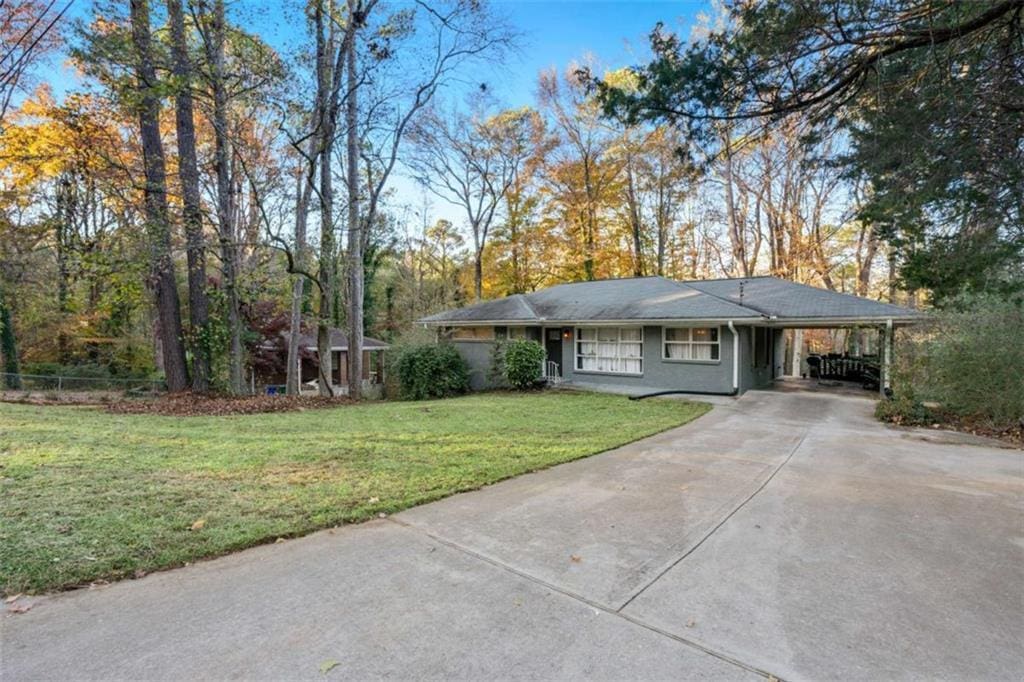 ranch-style house with a front lawn and a carport