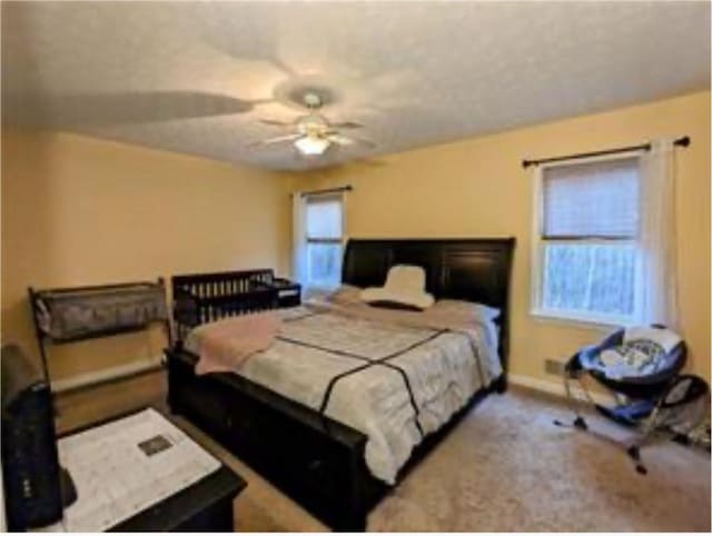 bedroom featuring ceiling fan and light carpet