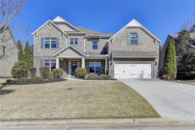 view of front of house featuring brick siding, an attached garage, concrete driveway, and a front yard